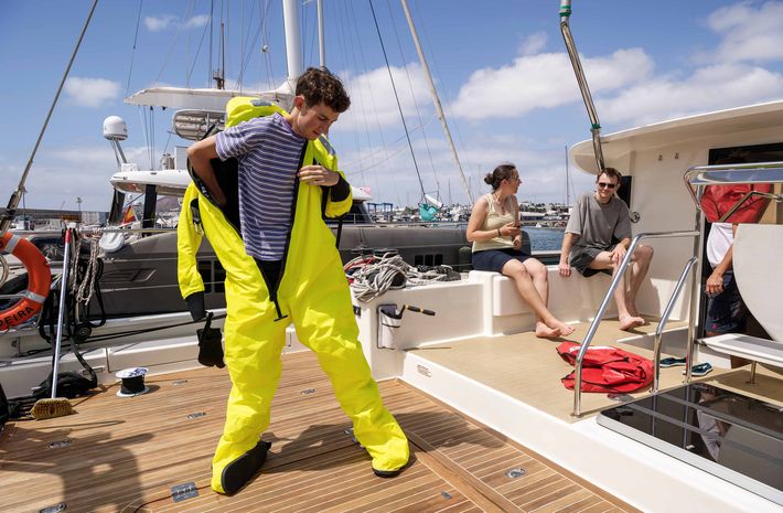 Intern Jonas Schneider demonstrates how to use the immersion suit that can protect the wearer for several hours in cold water.