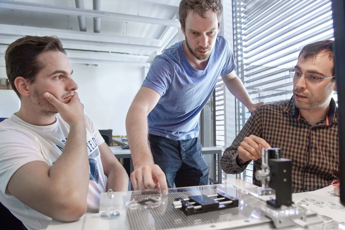 Photo of a team discussion about the artificial muscle.