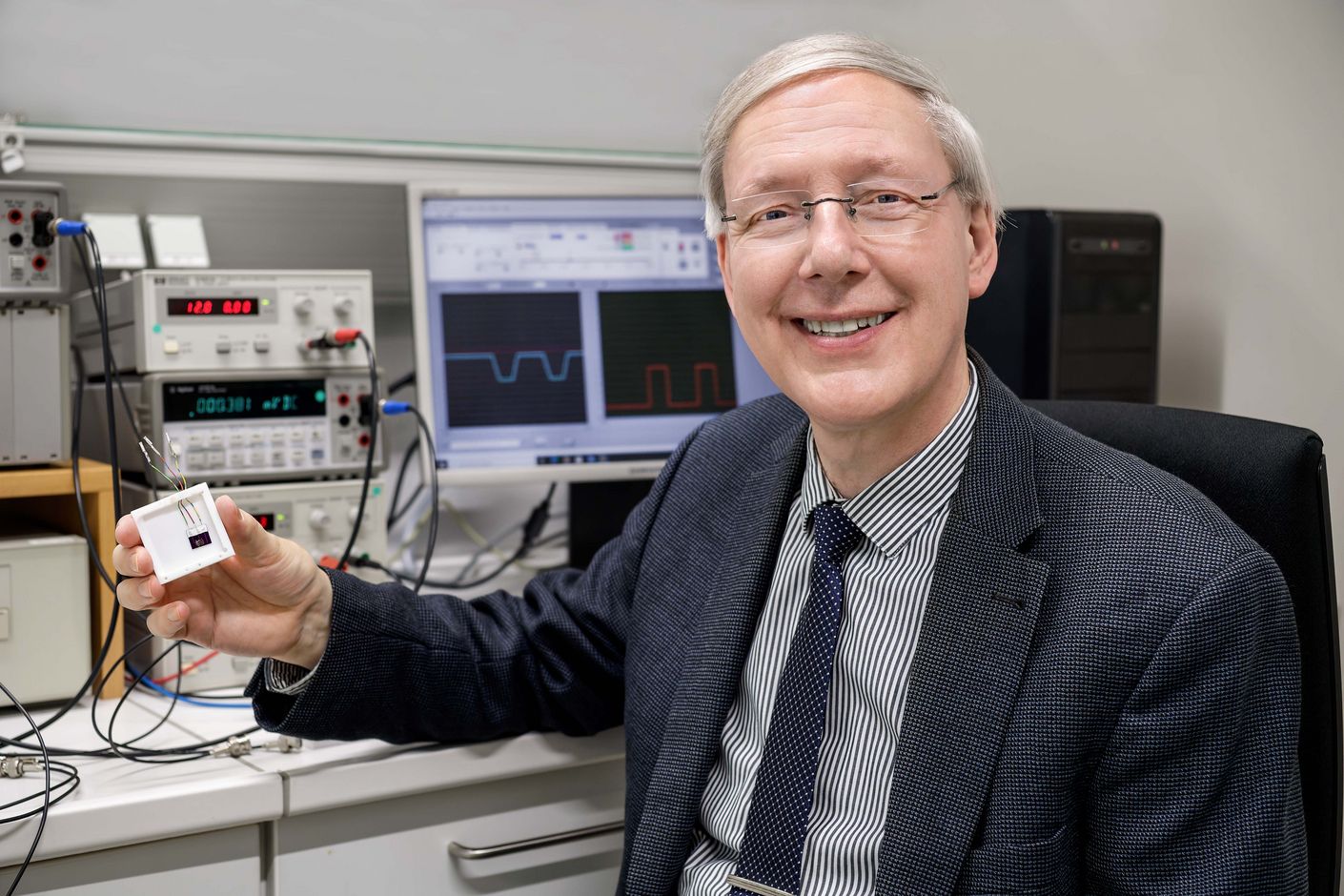 [Translate to English:] Der Physiker Thomas Schimmel hält seine Erfindung, den in Gel gegossenen Einzelatom-Schalter, in der Hand.