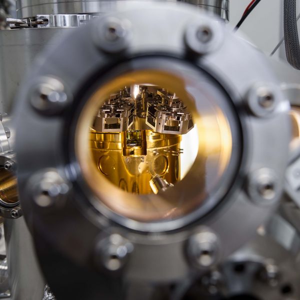 A glimpse through the peephole into the shimmering golden chamber of the scanning tunnelling microscope, where material samples are measured under vacuum conditions.