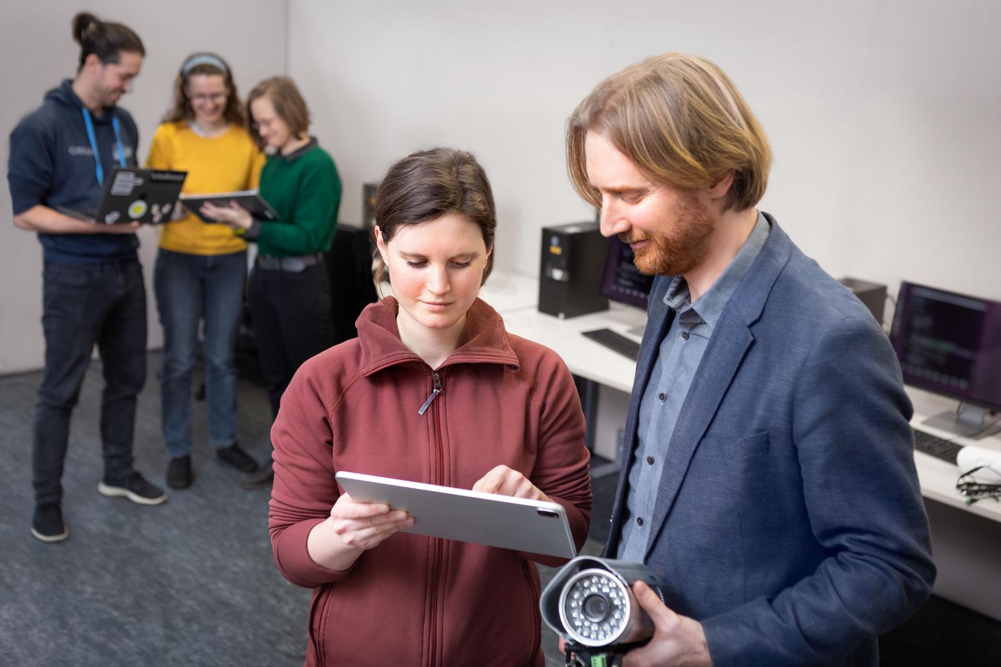 Matthew Smith and a researcher look at a tablet