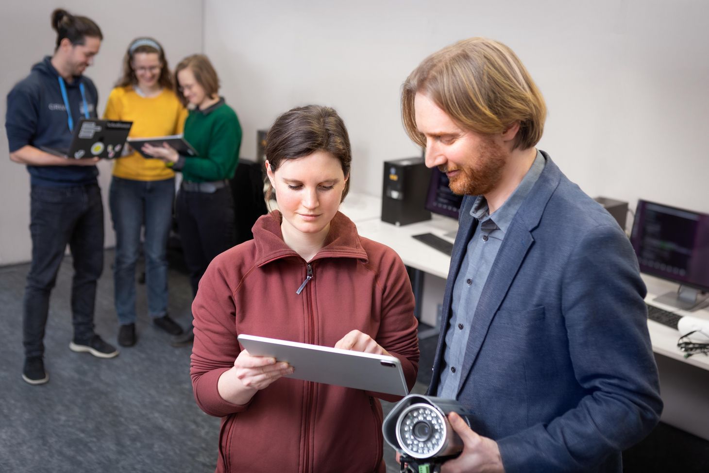 Matthew Smith and a staff member look at a tablet.