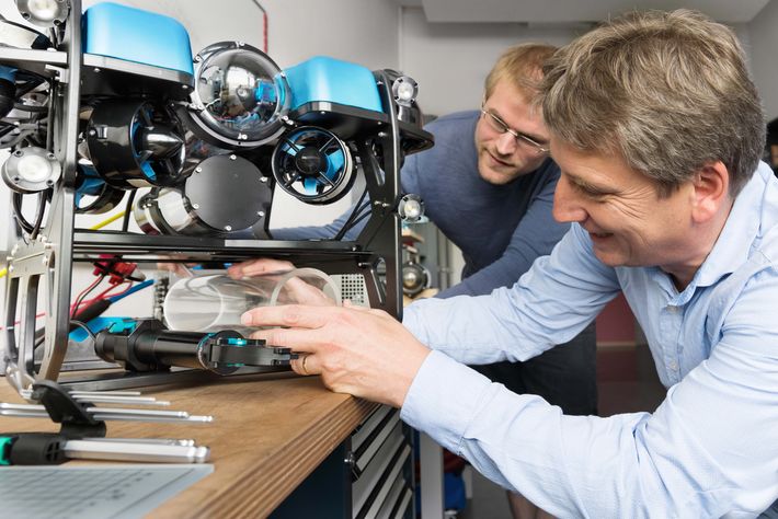 Photo of Werner Siemens Foundation Endowed Chair Ralf Bachmayer (right) and his colleague Paul Riesen with a remote-controlled underwater vehicle.